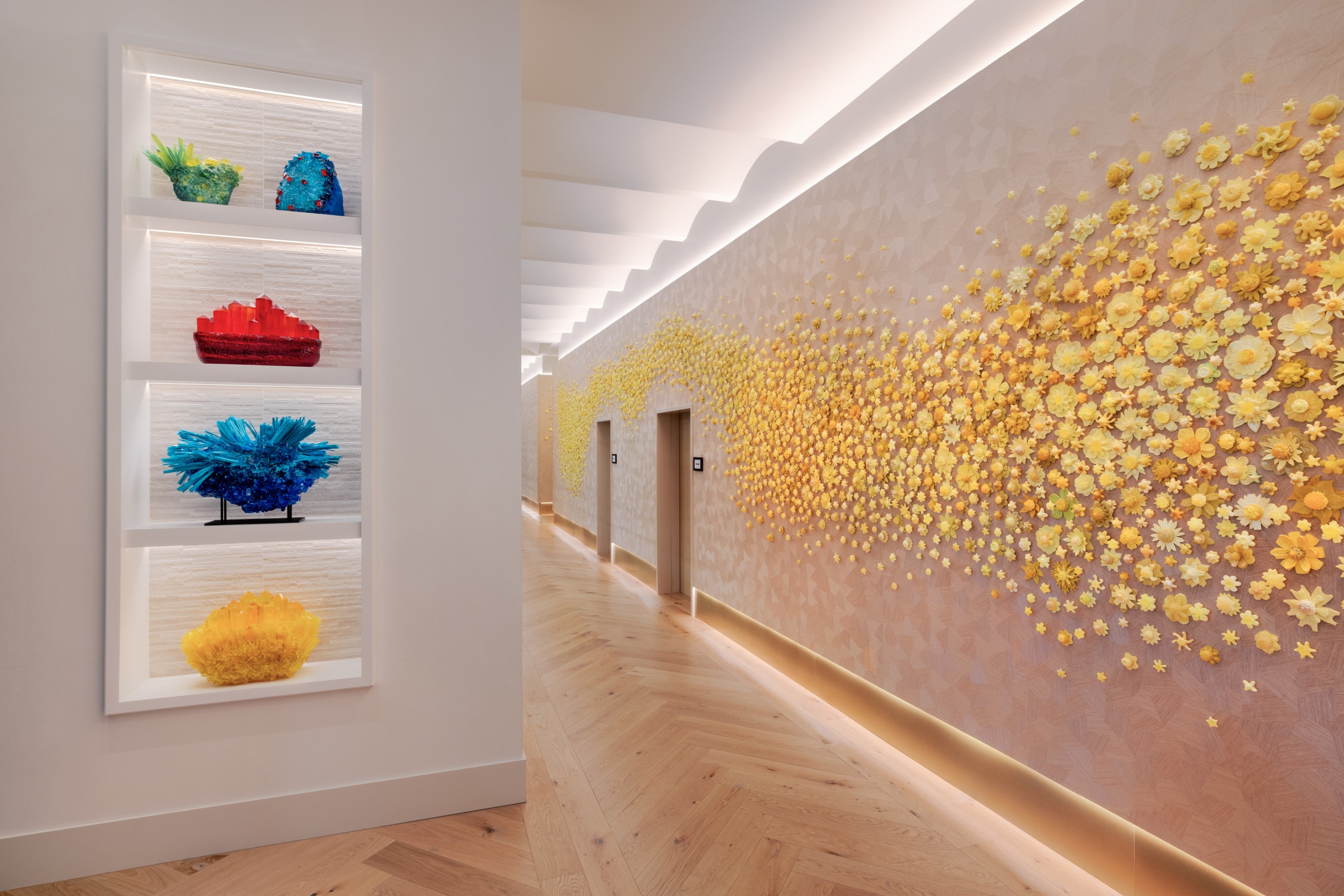 Wall art of yellow flowers and artwork displayed on a bookshelf